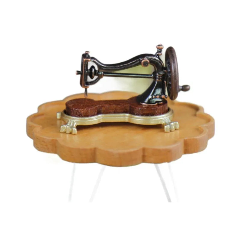 Brown metal simulation mini hand sewing machine dollhouse accessory on display