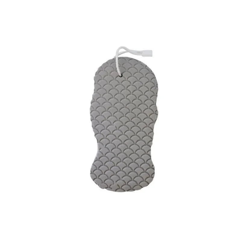 White 3D fish scale pattern bath sponge ball on a bathroom surface.