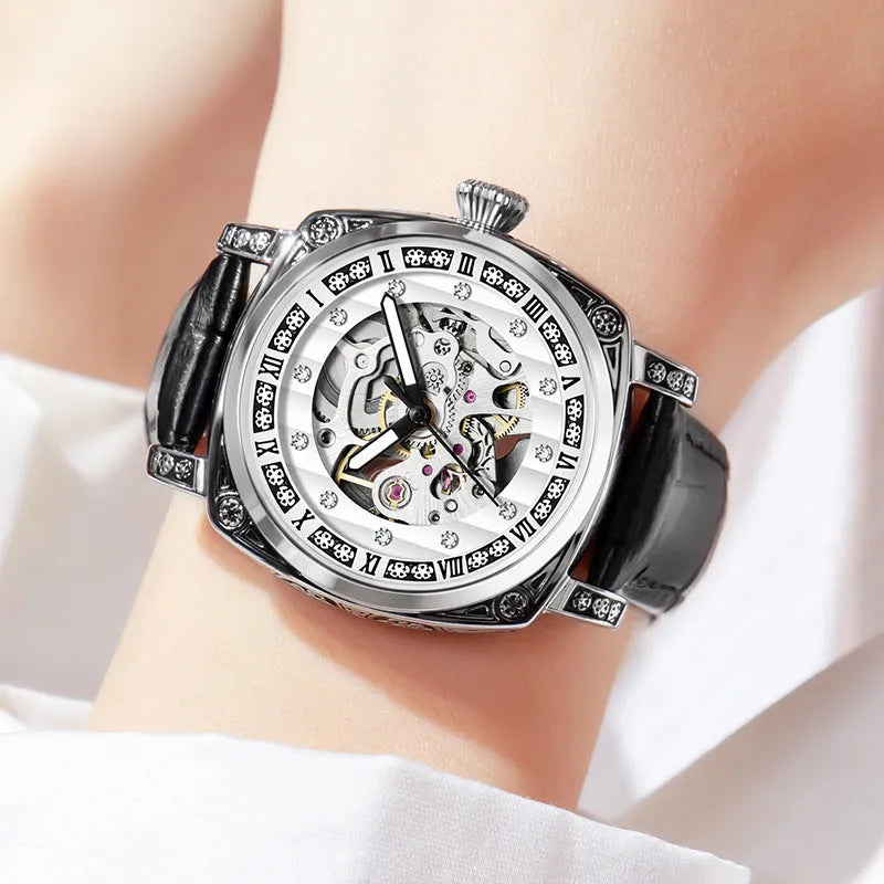 Mechanical watch with luminous hands and a brown leather strap, showing white dial.