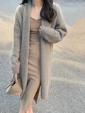 Women's khaki loose-fit knitted V-neck cardigan on a hanger, showing mid-length and long sleeves.