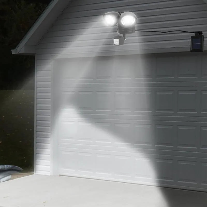 Black and white solar security spotlight with dual motion sensors for outdoor use