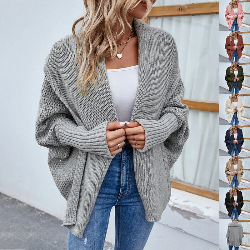 A cozy, oversized knit cardigan with a unique bat-wing sleeve design and large lapel, available in a variety of stylish colors.