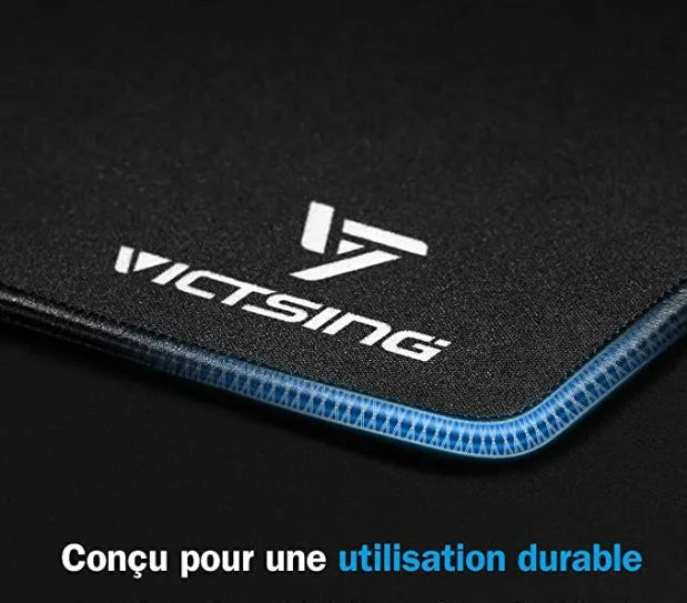 Black thickened rubber mouse pad with rough grain surface texture on desk