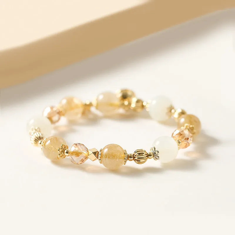 Gold electroplated adjustable chain bracelet with a rutilated quartz crystal in Lucky Fortune colour.