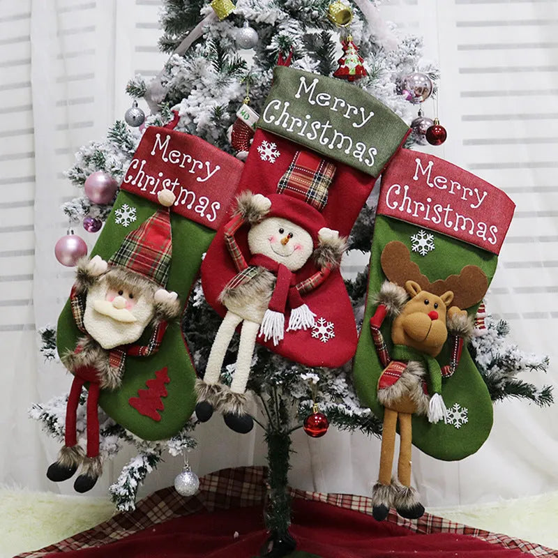 Three large Christmas stockings with Santa, Snowman, and Reindeer 3D applique designs hanging from a mantel