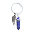 Natural stone bag hanging ornament pendant with metal key ring on a blue background