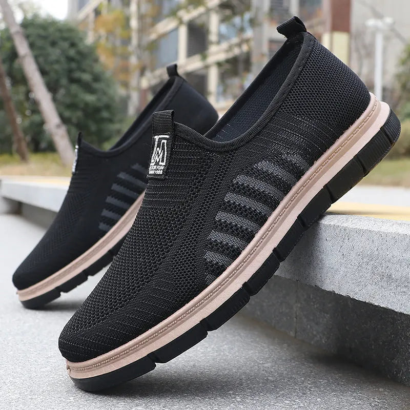 Slip-on soft bottom casual sneakers for men in black with mesh upper and low-top design