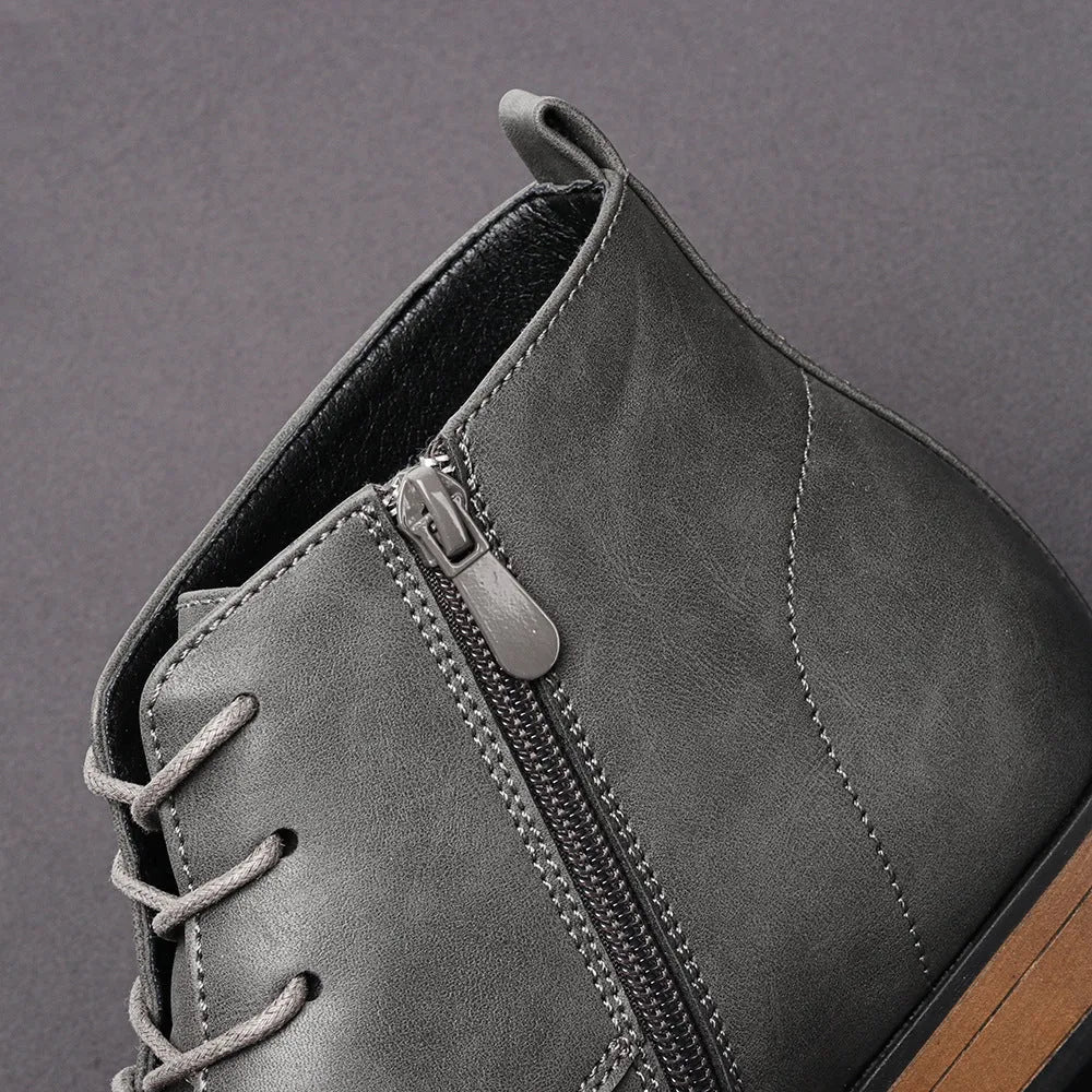 Men's brown Chelsea ankle boots with a side zip, shown on a foot.