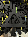 PVC freestanding dumbbell rack bracket holding multiple weights on a gym floor.