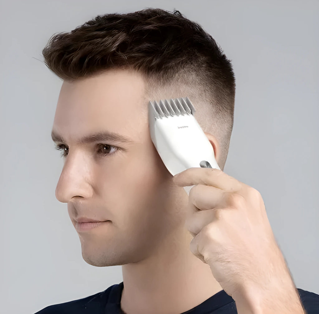 Black cordless electric hair clipper with adjustable comb and ceramic cutter head on a white background