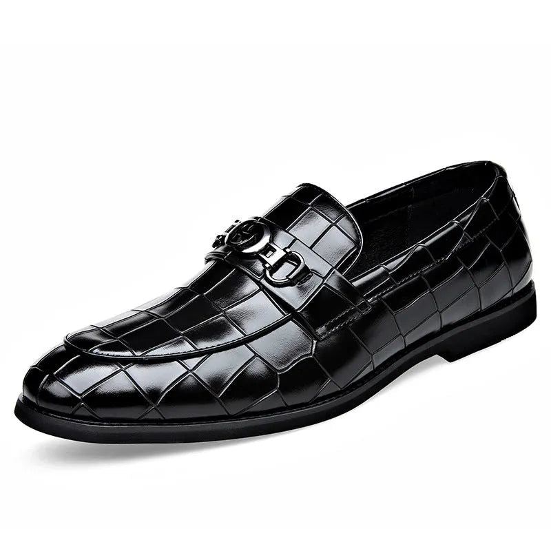 Men's casual leather shoes with embossed horsebit buckle in black, side view showing flat wedge heel and rubber sole