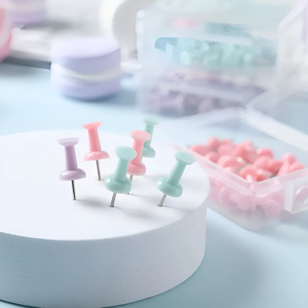 Box of 40 plastic push pins in macaron colours: cherry blossom pink, mint green and lavender.