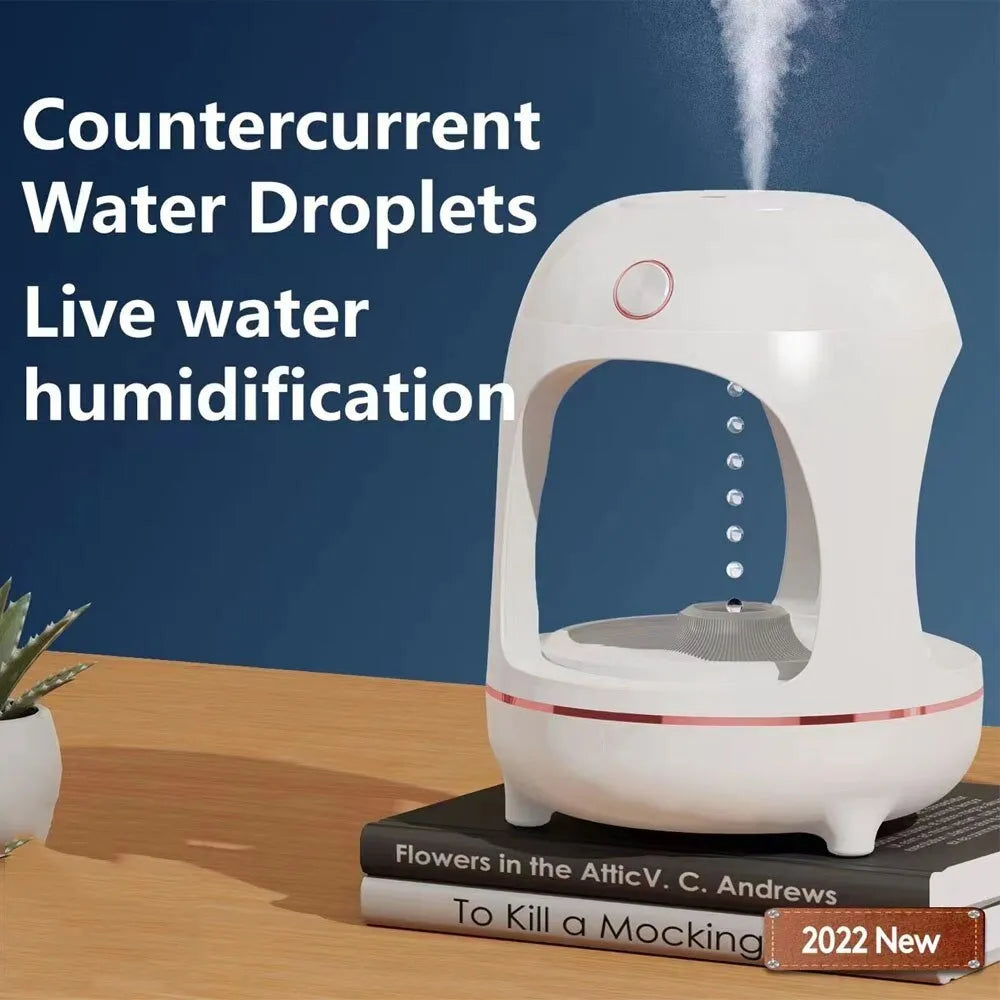 Rose gold and white columnar humidifier with levitating water drops and LED glow on a desk