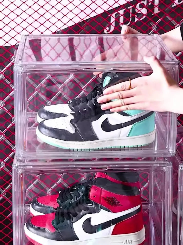 Transparent acrylic shoe storage box with magnetic side door showing shoe inside
