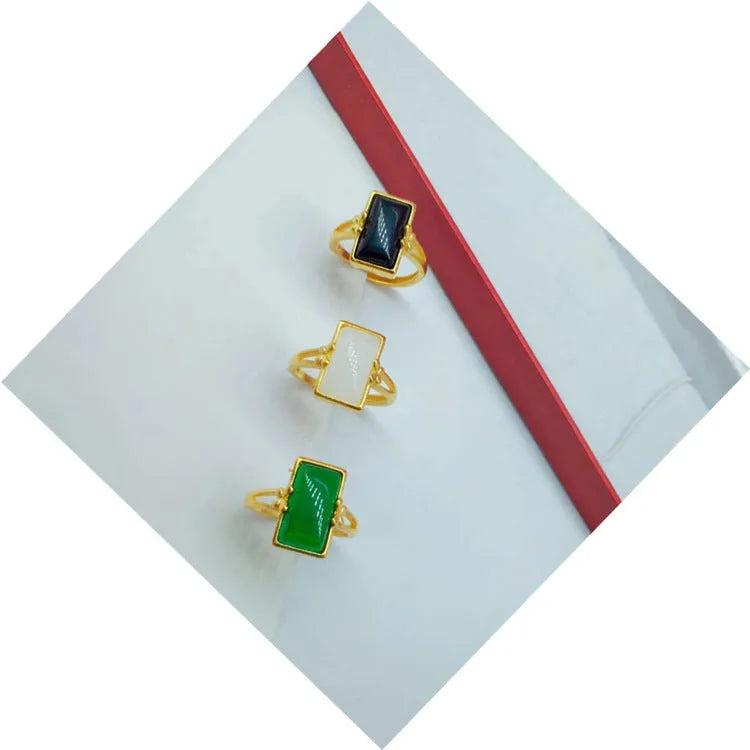 Adjustable brass gold-plated ring with a green gemstone set in a national style design.