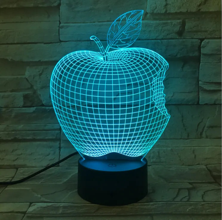 3D fruit-shaped colourful LED night light with touch control on a surface.