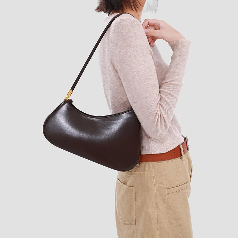 Women's oval-shaped retro underarm bag in various colours with a single shoulder strap.
