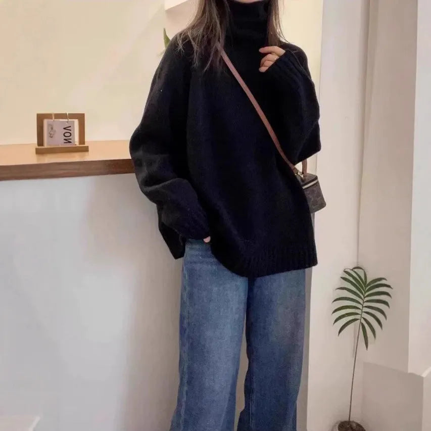 Women's loose thick grey turtleneck sweater with curling pile collar, casual pullover style.