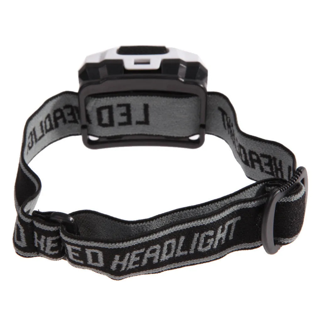 Black waterproof head torch with white and red LEDs, worn on head strap for outdoor activities.