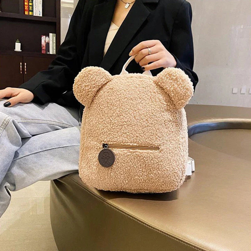 Cute, bear-shaped backpack made of soft, fleece material in various colors for casual travel and daily use