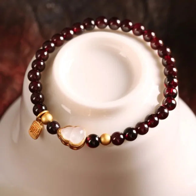Chinese style gourd bracelet with imitation garnet beads and traditional Fu character charm on adjustable U-shaped design