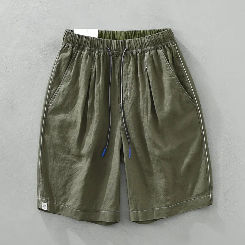 Men's loose straight fit linen shorts in green with drawstring waist, shown laid flat