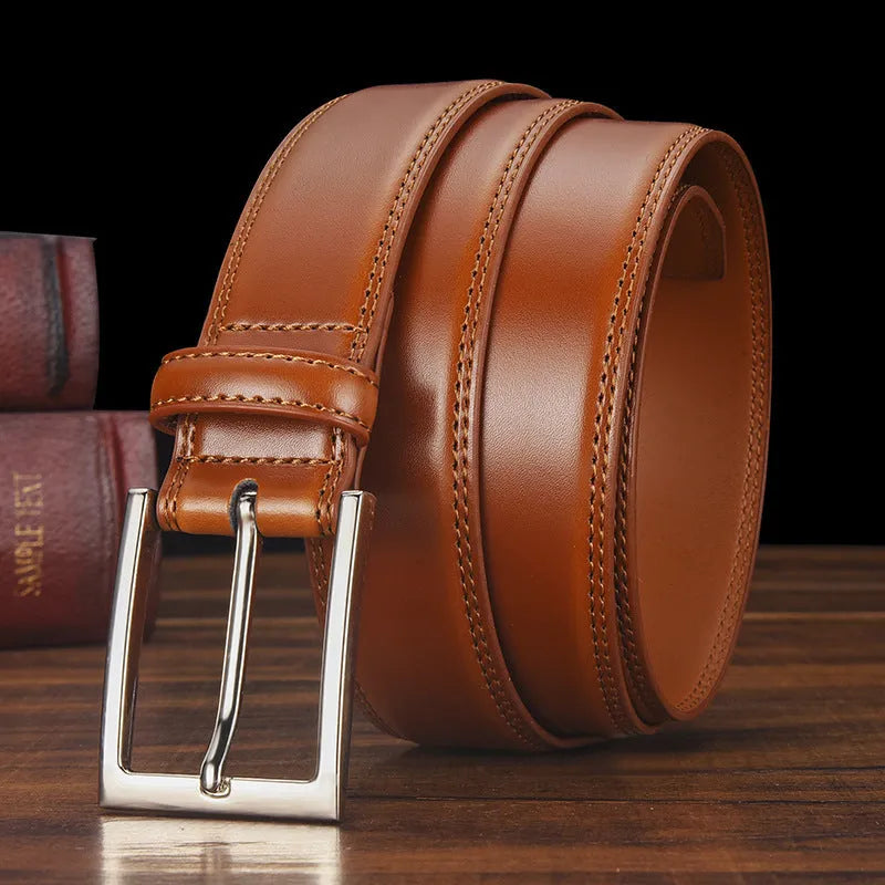 Men's black genuine leather belt with a silver pin buckle shown on a flat surface