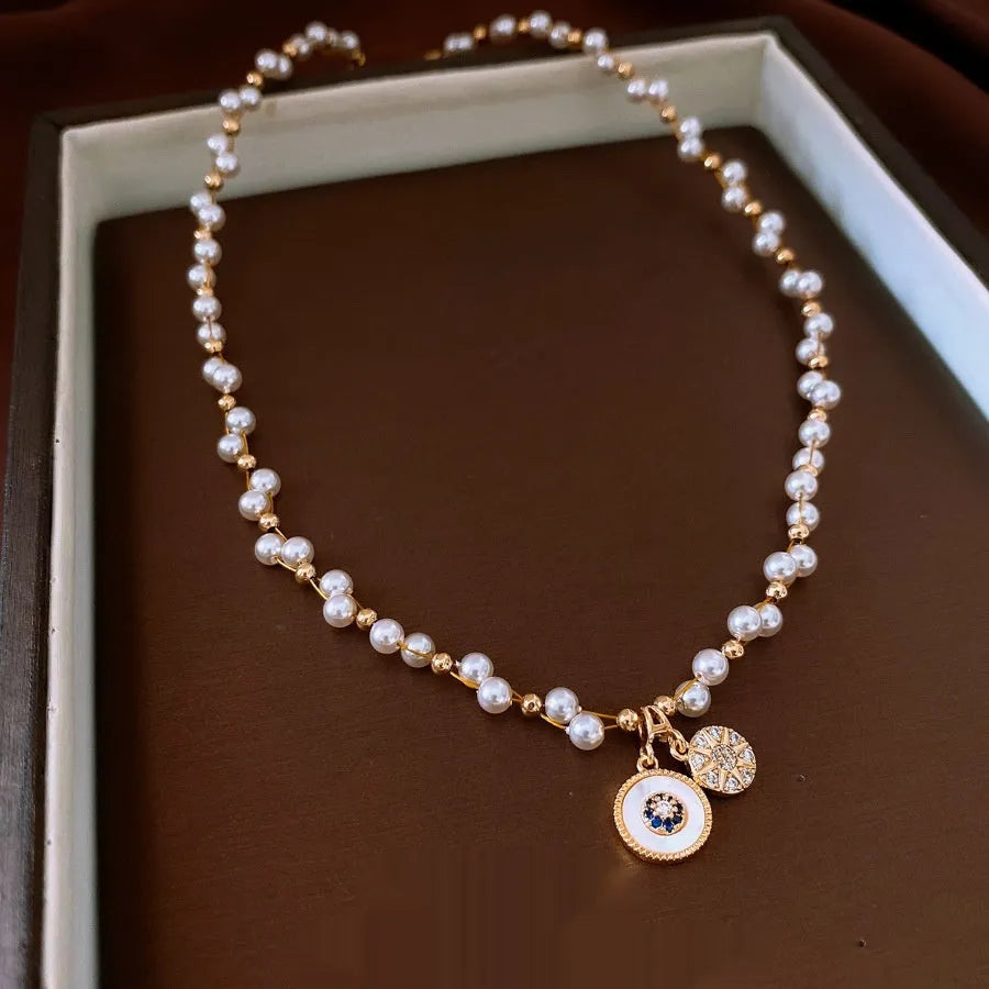 Gold electroplated necklace with white round pearl pendant on clavicle chain