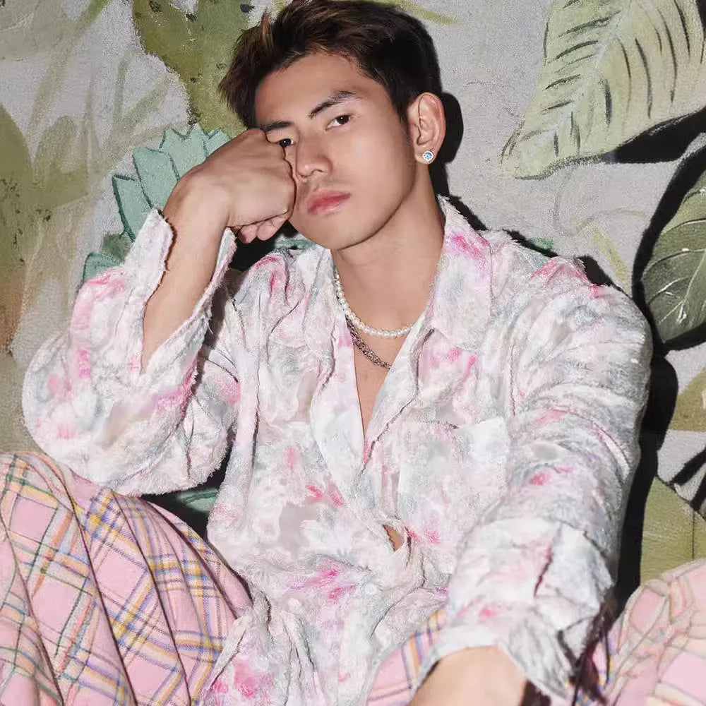 Pink loose fit floral long sleeve shirt with embossed three-dimensional pattern on a hanger.
