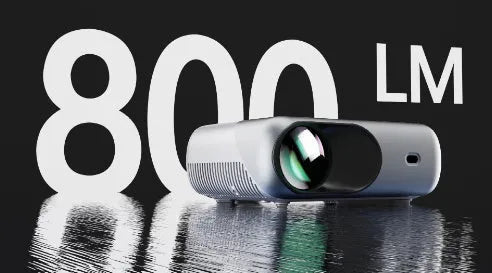 White portable WiFi HD 1080p projector with focus ring and remote control on a table
