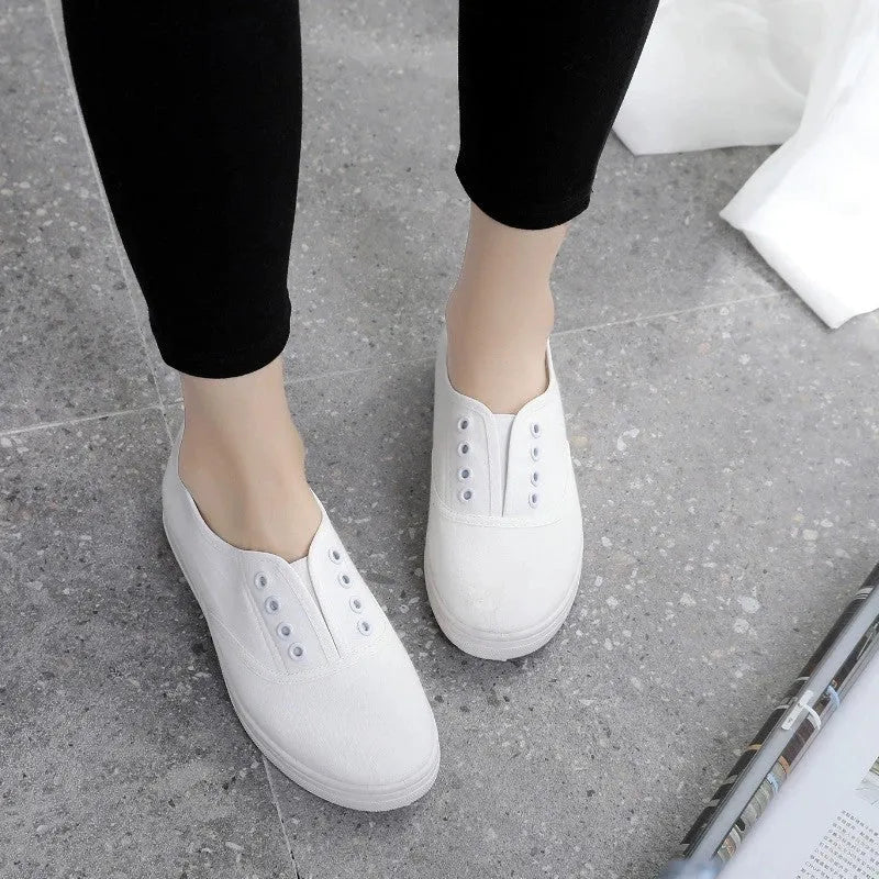 Low-top canvas trainers in black, white, grey and pink colours with plastic sole
