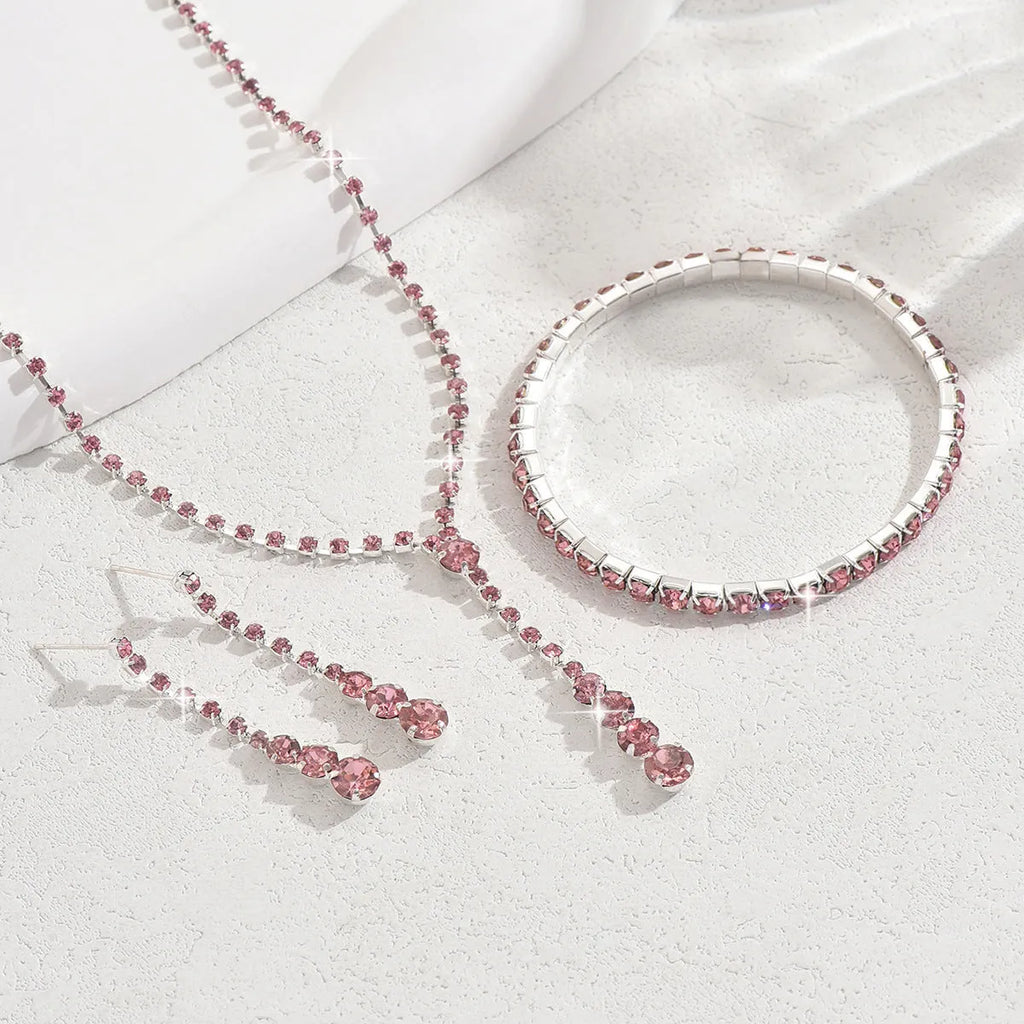 Bridal jewellery set with rhinestone heart necklace, elastic bracelet, and matching earrings with tassel details