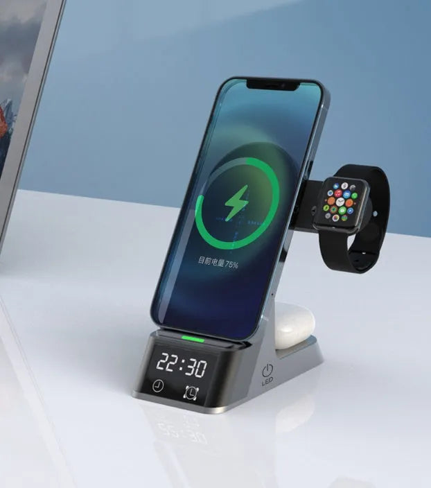 Black multifunctional wireless charging alarm clock with digital display and phone on charging pad.
