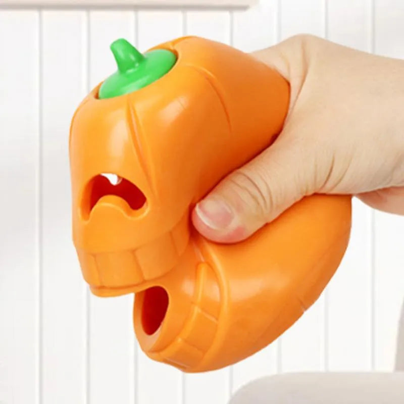 Yellow pumpkin-shaped TPR dog chew toy for aggressive chewers on a white background.