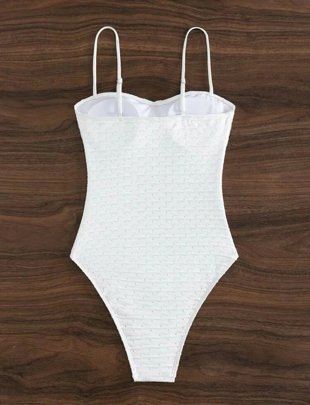White women's one-piece swimsuit with sling design on mannequin