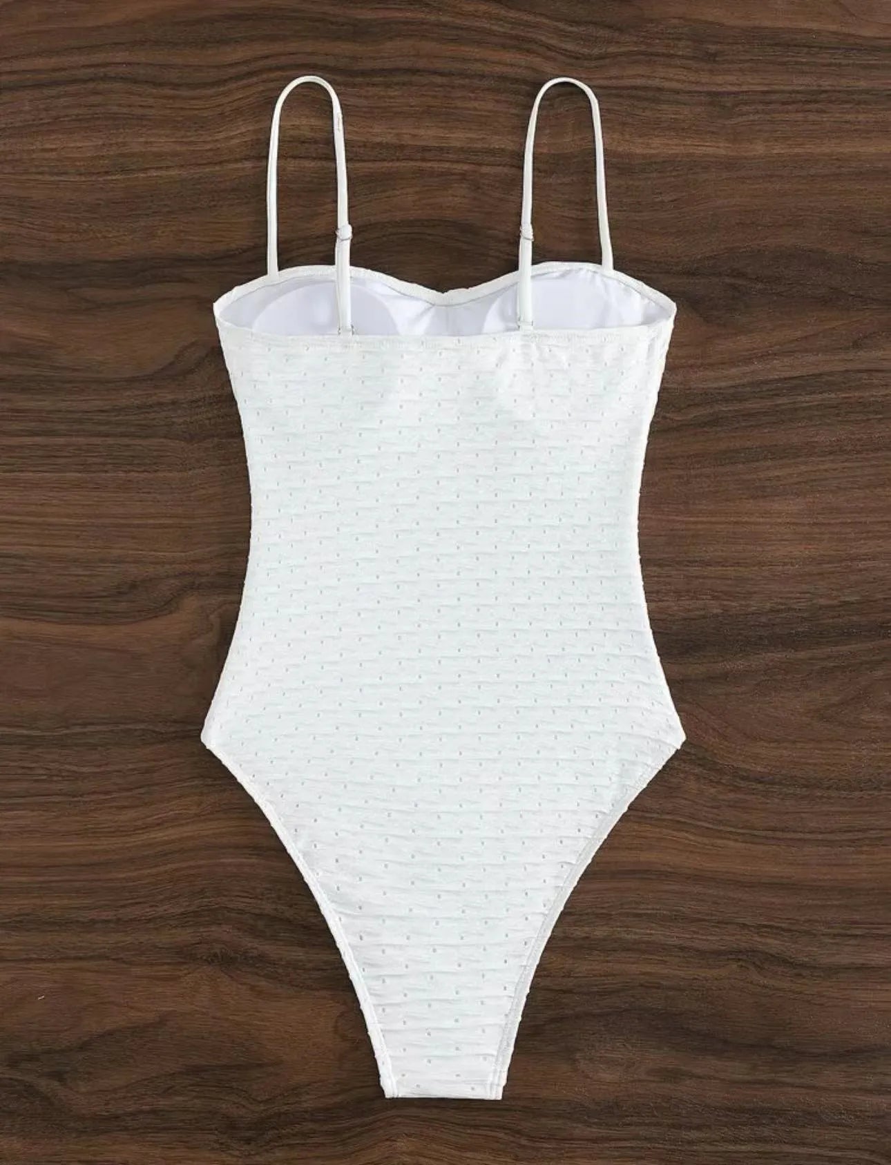 White women's one-piece swimsuit with sling design on mannequin