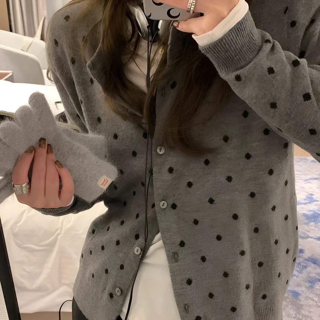 Women's loose grey knitted cardigan with crocheted dot flowers, long sleeves.