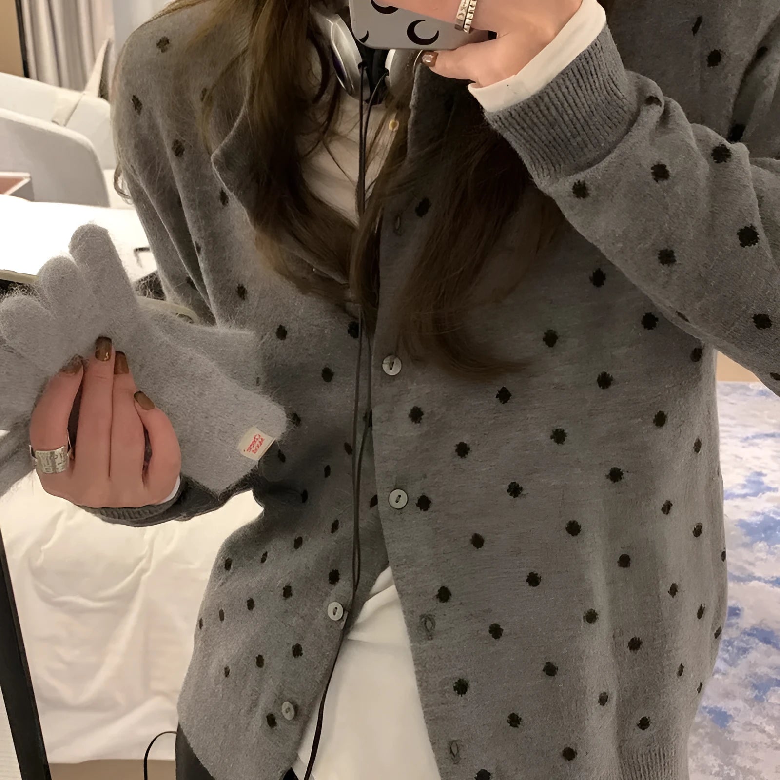 Women's loose grey knitted cardigan with crocheted dot flowers, long sleeves.