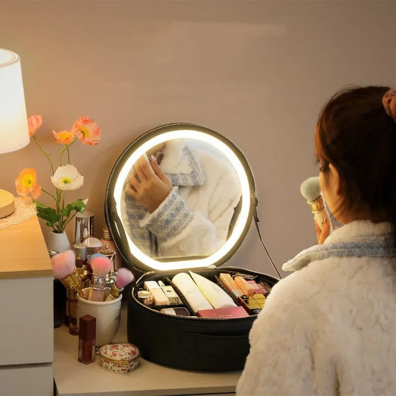 Round pink LED makeup bag open showing internal partitions and illuminated mirror.