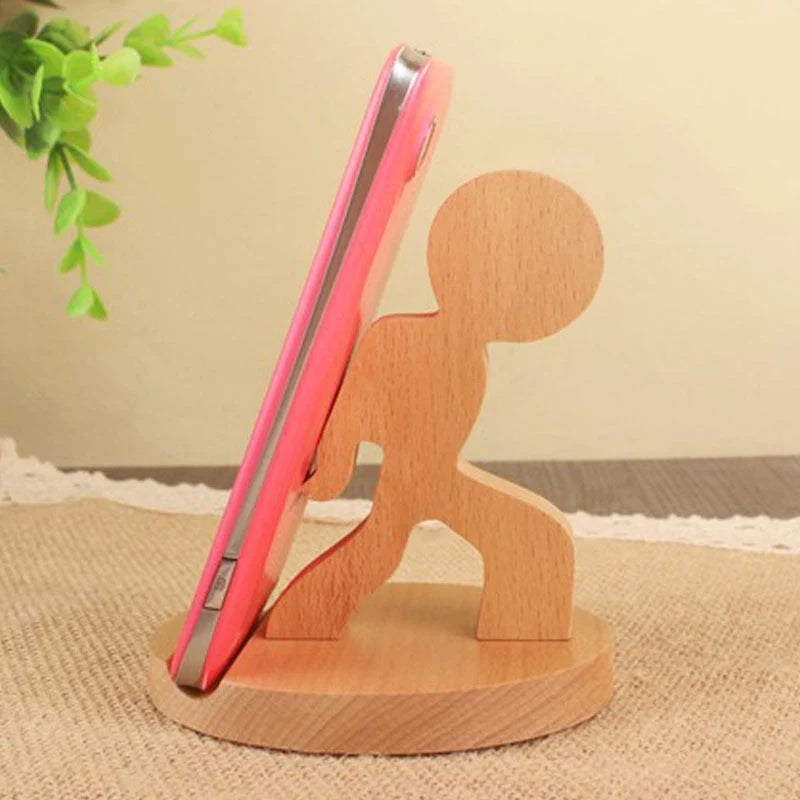 Custom lettering beech wood lazy phone holder with coin slot on a wooden table
