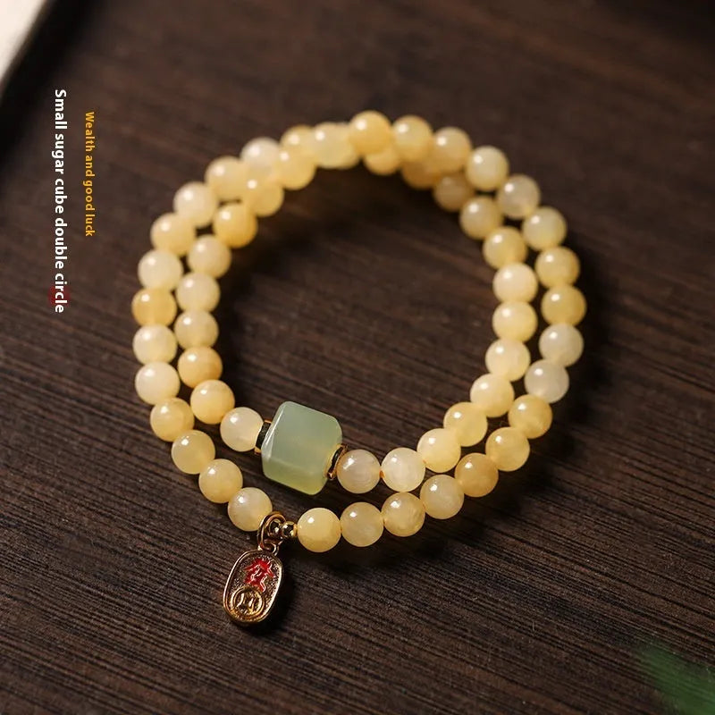 Topaz-coloured women's bracelet with six-word mantra barrel beads and sugar jade cubes in hand-woven design