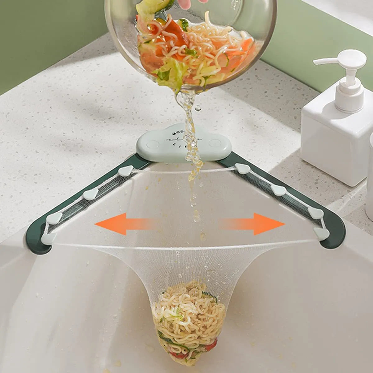 Green triangular sink drain rack with mesh filter bag installed in a kitchen sink corner