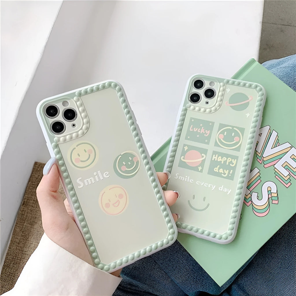 Green TPU iPhone back cover with geometric pattern featuring smiley faces and a polka dot frame.