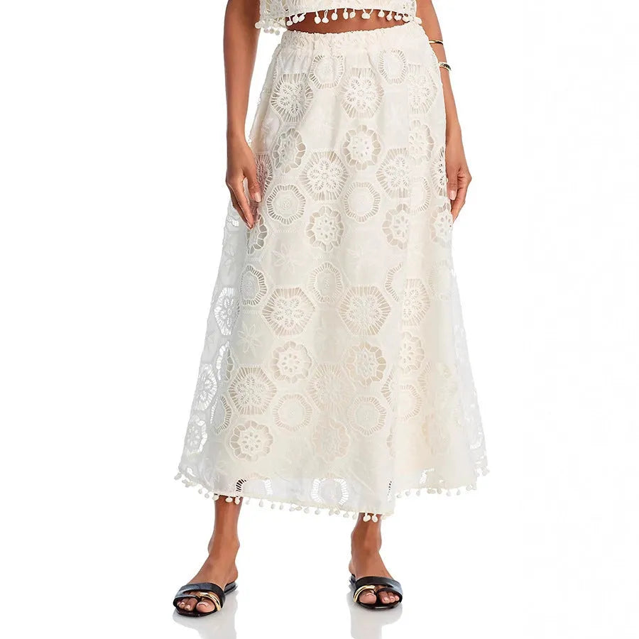 White women's sleeveless top and long skirt suit set with retro embroidery details.
