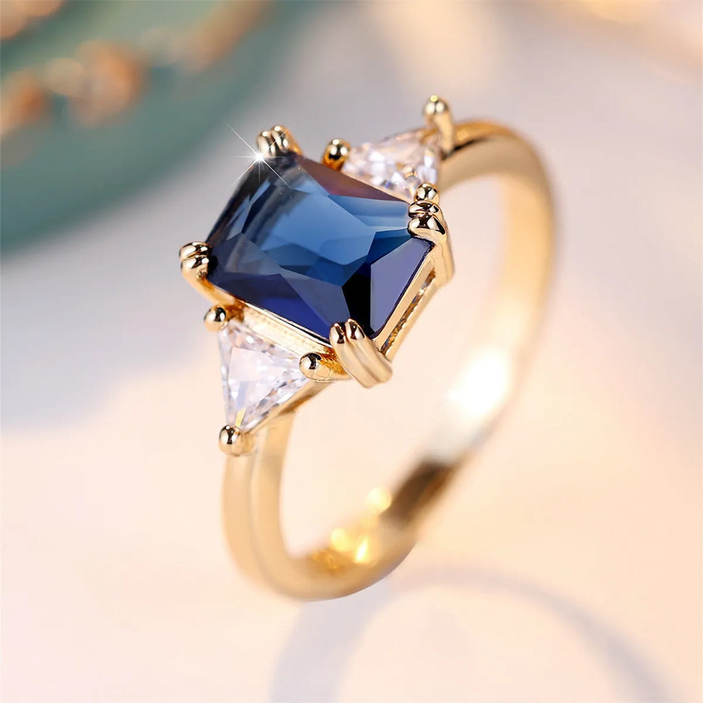 Rectangular copper ring with gold sapphire blue finish, shown on hand