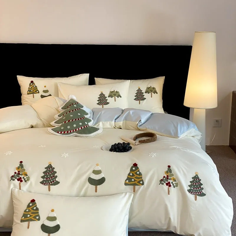 Cream blue cotton duvet cover and pillowcases with embroidered green Christmas tree and flower design.