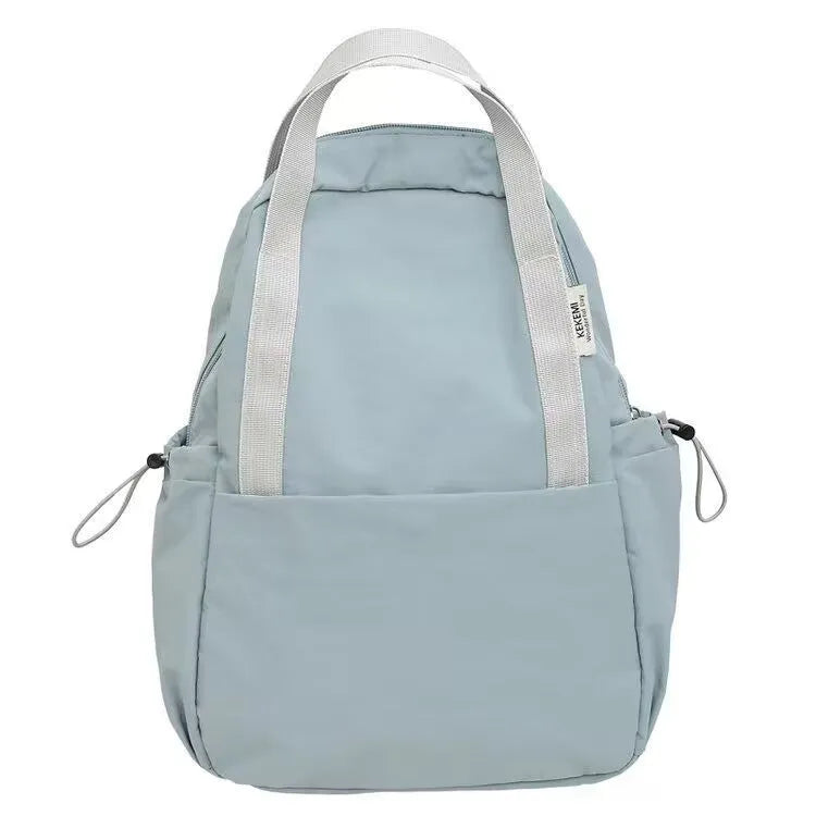 Solid colour ultra-light waterproof nylon backpack with curved shoulder straps on a white background