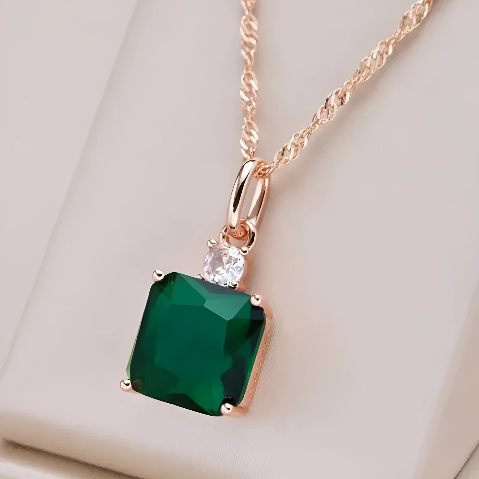Green electroplated stainless steel clavicle chain with geometric quadrilateral pendant on O-ring chain