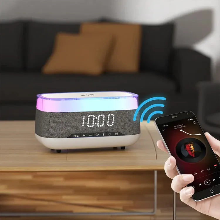 White multifunctional alarm clock with Bluetooth speaker and wireless charging pad for mobile phones