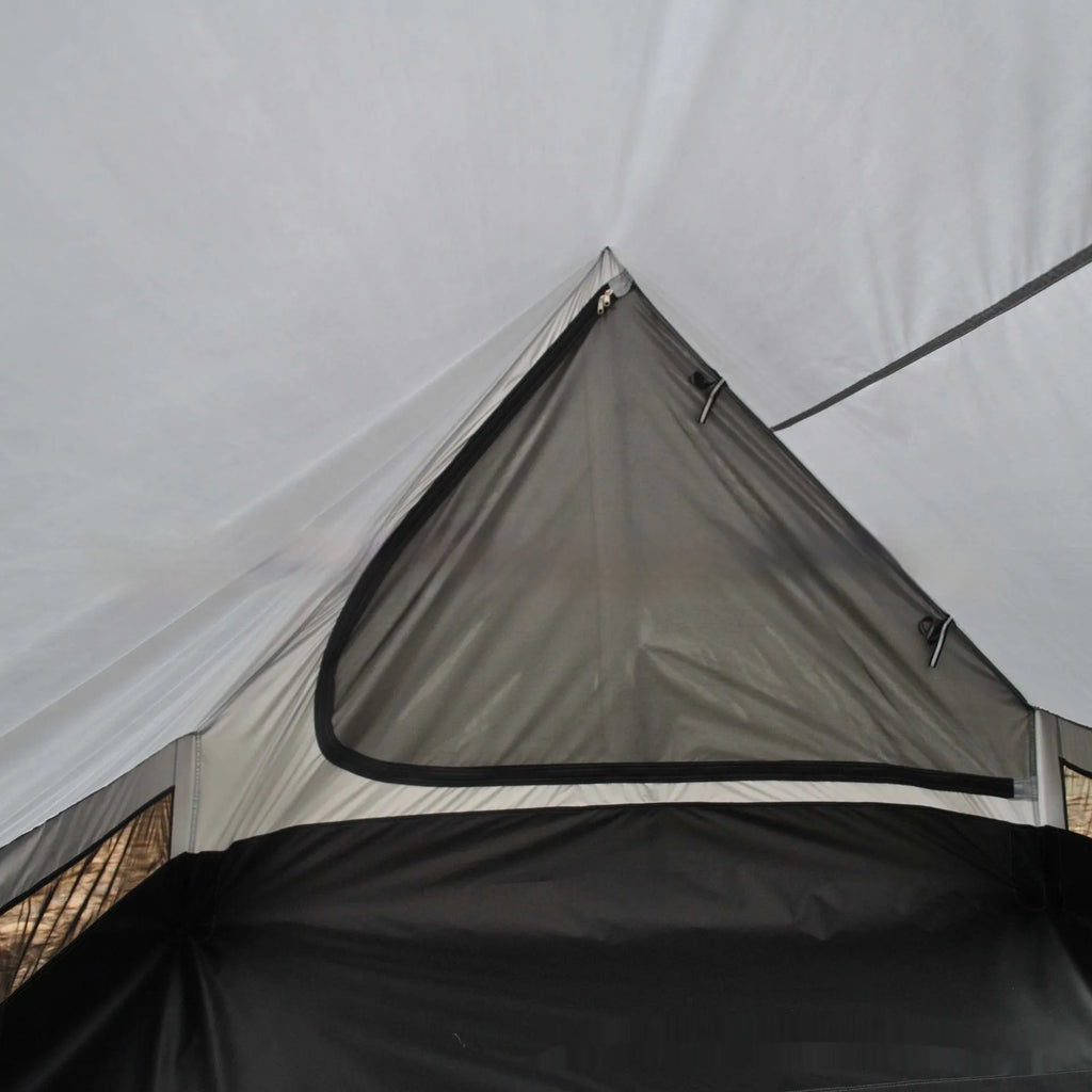 Lightweight brown A-line hiking tent set up with hiking cane supports in outdoor setting